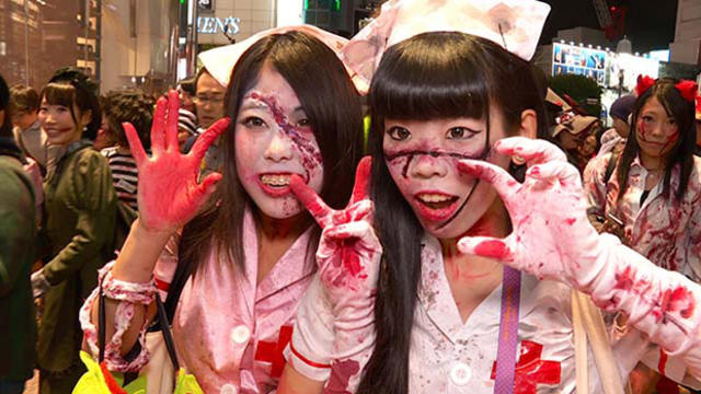 Two Japanese women pose in bloody nurse costumes ​in the Shibuya district of Tokyo, Japan, Oct. 31, 2015. 