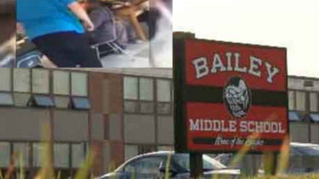 In inset, upper-left, teacher David Pfaff is seen in still from video showing him yanking chair from under student at Bailey Middle School in West Haven, Connecticut during week of November 2, 2015 