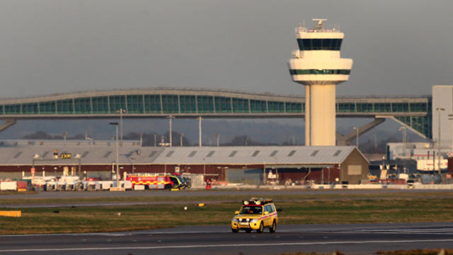 An emergency vehicle inspects the runway at Gatwick Airport in West Sussex Dec. 29, 2014, in London, England. 