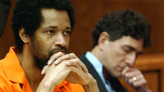 Convicted sniper John Allen Muhammed, left, listens to testimony as his attorney, Jonathan Shapiro, sits next to him prior to being sentenced for the shooting of Dean Meyers at Prince William County Circuit Court March 9, 2004, in Manassas, Virginia. 