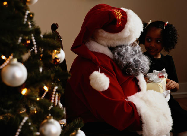 Girl With Santa Claus by a Christmas Tree 
