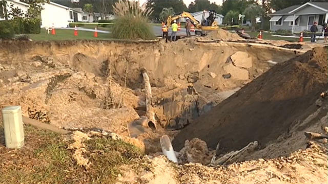 Crews work the scene after a large sinkhole opened in Ocala, Florida, Dec. 10, 2015. 