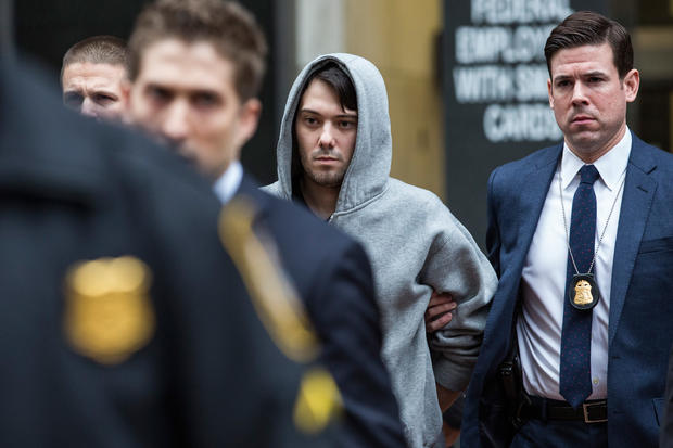 Martin Shkreli, center, CEO of Turing Pharmaceuticals, is brought out of 26 Federal Plaza by law enforcement officials after being arrested for securities fraud Dec. 17, 2015, in New York City. 