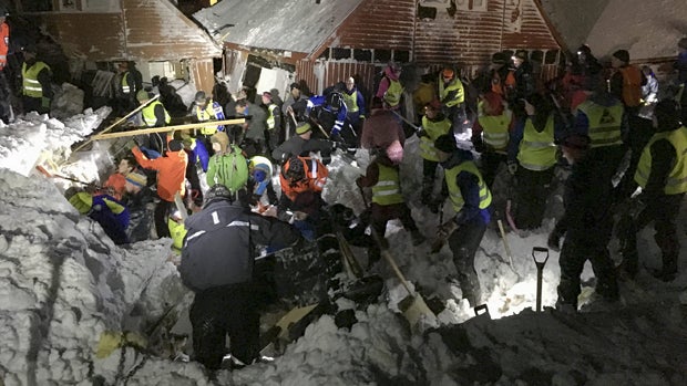 A search crew works in an area hit by an avalanche in Longyearbyen, the main settlement of the remote Arctic archipelago of Svalbard, Norway, Dec. 19, 2015. 