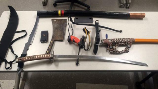 Police in Foxborough, Massachusetts, display weapons they say were seized from a man's car in a Gillette Stadium employee parking lot Jan. 1, 2016. 