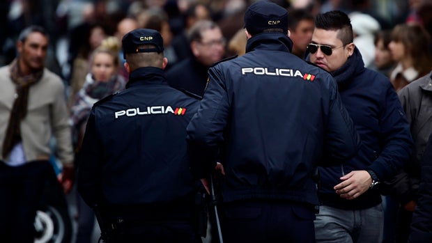 Spanish policemen patrol at Puerta del Sol square in the center of Madrid Dec. 31, 2015. 