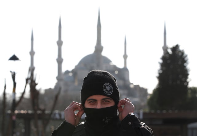 Backdropped by the Sultan Ahmed Mosque, better known as the Blue Mosque in the historic Sultanahmet district of Istanbul, a police officer secures the area after an explosion Jan. 12, 2016. The explosion killed several people and wounded 15 others.