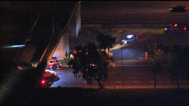 ​Crews work the scene after a SUV went off a highway overpass in Phoenix Jan. 13, 2016. 