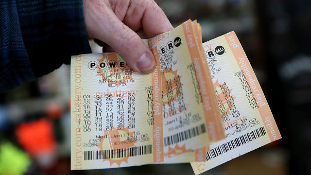 A customer holds a handful of Powerball tickets at Kavanagh Liquors on Jan. 13, 2016, in San Lorenzo, California. 