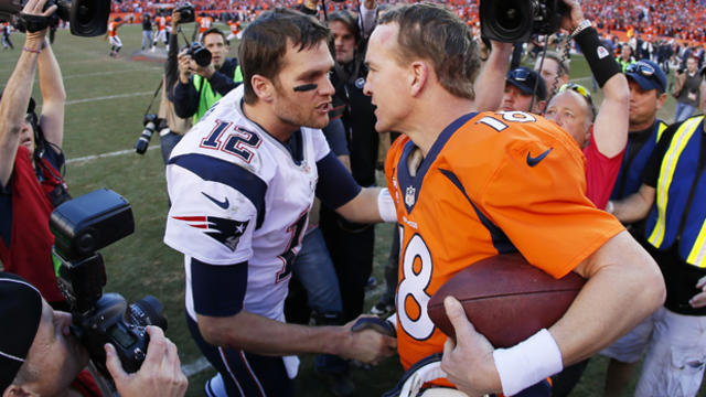 Tom Brady, No. 12 of the New England Patriots, congratulates Peyton Manning, No. 18 of the Denver Broncos, after the Broncos defeated the Patriots 26 to 16 during the AFC championship game at Sports Authority Field at Mile High on Jan. 19, 2014, in Denver 