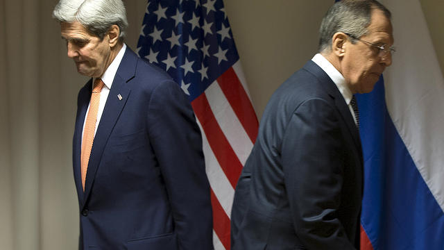 U.S. Secretary of State John Kerry and Russian Foreign Minister Sergey Lavrov walk to their seats for a meeting about Syria in Zurich, Switzerland, Jan. 20, 2016. 