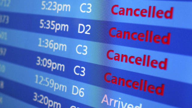 ​Canceled flights are displayed on a status board at New York's Laguardia Airport ahead of a powerful winter storm Jan. 22, 2016. 