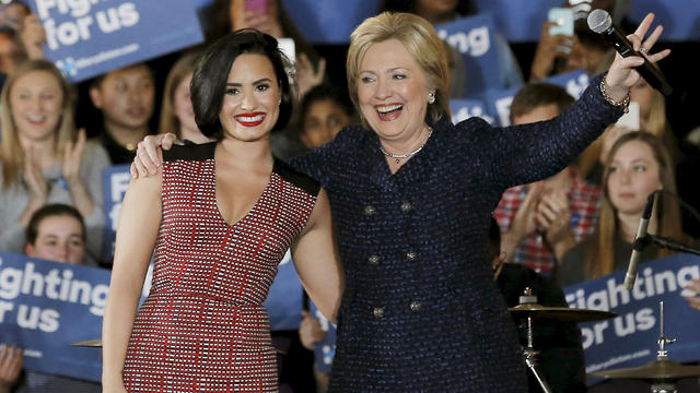 Democratic presidential candidate Hillary Clinton is joined by singer Demi Lovato at a campaign event in Iowa City, Iowa, Jan. 21, 2016. 