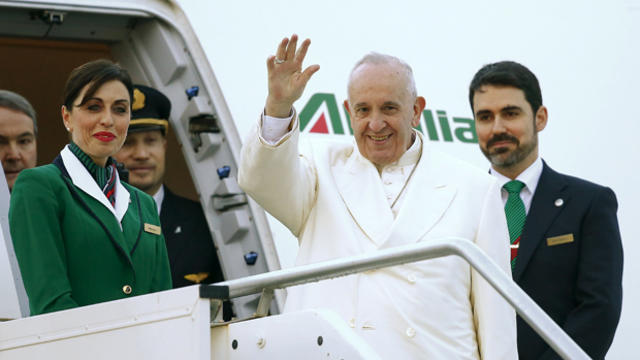 ​Pope Francis waves as he boards a plane at Fiumicino Airport in Rome, Italy, Feb. 12, 2016. 