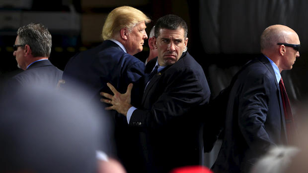 Secret Service agents surround Republican presidential candidate Donald Trump during a disturbance as he speaks at Dayton International Airport in Dayton, Ohio, March 12, 2016. 