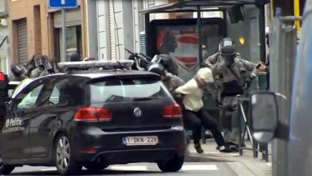 ​Armed Belgian police apprehend a suspect in this still image taken from video in the Molenbeek neighborhood of Brussels, Belgium, March 18, 2016. 