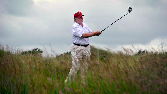 U.S. tycoon Donald Trump takes a swing as he officially opens his new multimillion-pound Trump International Golf Links course in Aberdeenshire, Scotland, on July 10, 2012. 