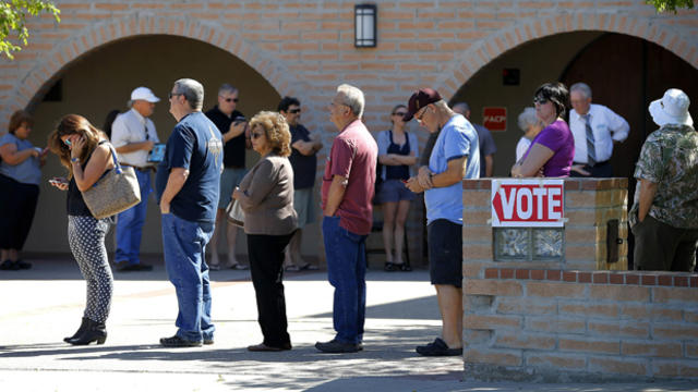 Voters wait in line to cast their ballot in Arizona's presidential primary election March 22, 2016, in Gilbert, Ariz. 