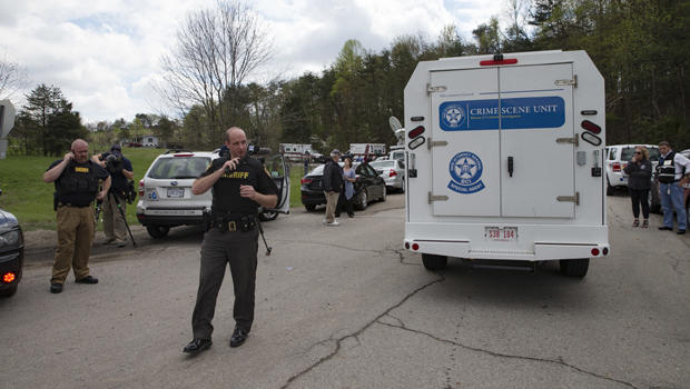 Authorities allow crime scene investigation vehicles to pass a perimeter checkpoint near a crime scene April 22, 2016, in Pike County, Ohio. 