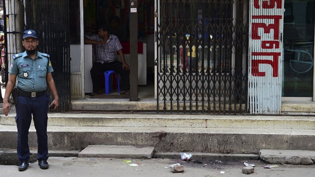A Bangladeshi policeman stands guard at the site of the murder of a law student, hacked to death by four assailants the night before, in Dhaka on April 7, 2016. 