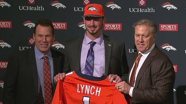 Paxton Lynch with Broncos general manager John Elway, right, and Gary Kubiak, left 