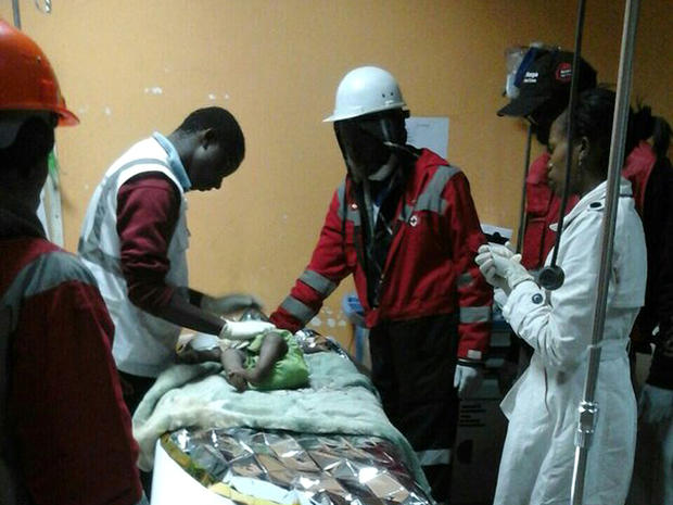 ​An image released by the Kenya Red Cross shows rescuers and medical workers caring for a 1-year-old girl rescued on May 3, 2016, from the rubble of a collapsed building in Nairobi 