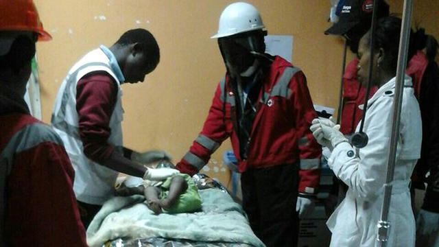 ​An image released by the Kenya Red Cross shows rescuers and medical workers caring for a 1-year-old girl rescued on May 3, 2016, from the rubble of a collapsed building in Nairobi 
