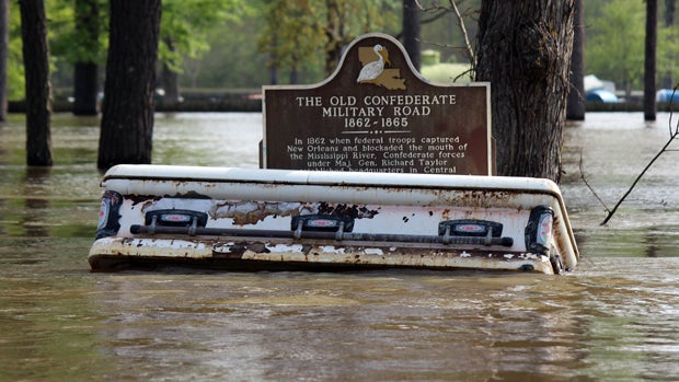 A casket floats away from a cemetery during flooding from heavy rains in Calcasieu Parish, La., March 16, 2016. 