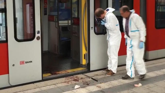 ​German forensic police investigators photograph the scene of a stabbing attack at the Grafing train station in southern Germany, near Munich 