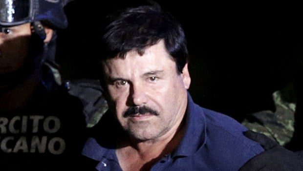 Recaptured drug lord Joaquin "El Chapo" Guzman is escorted by soldiers at the hangar belonging to the office of the attorney general in Mexico City, Mexico, Jan. 8, 2016. 