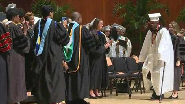 ​Aaron Willis walks across the stage during the graduation ceremony for Booker T. Washington High School in Miami June 1, 2016. 