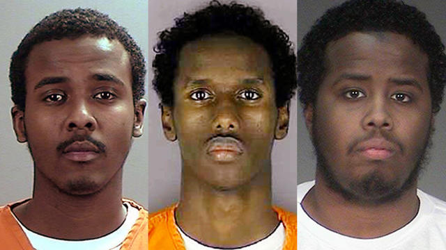 From left, ​Abdirahman Yasin Daud, Guled Ali Omar and Mohamed Abdihamid Farah are seen in police booking photos. 