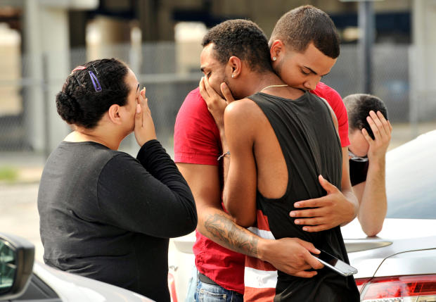 Friends and family members embrace outside Orlando police headquarters during the investigation of a shooting at the Pulse nightclub, where a gunman carried out the deadliest terror attack on U.S. soil since 9/11, in Orlando, Florida, June 12, 2016. 