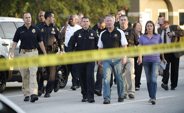 Orlando Mayor Buddy Dyer, center right, and Orlando Police Chief John Mina, center left, arrive to a news conference after a fatal shooting at Pulse nightclub in Orlando, Florida, on June 12, 2016. 