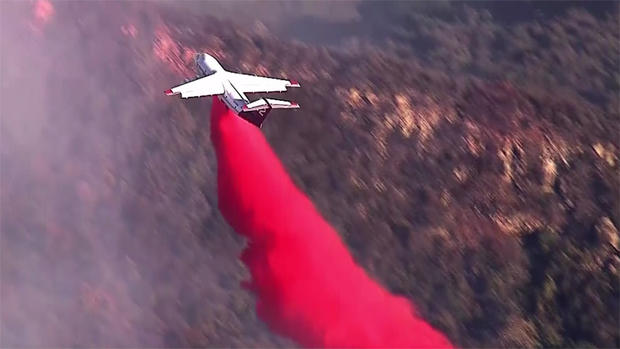 A Firefighing Plane Dumps Retardant Over Coastal California Blaze 
