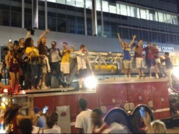 ​Cleveland Cavaliers fans in Cleveland mounted firetruck during celebration of Cavs' win over Golden State Warriors in NBA Finals Game 7 on June 19, 2016 in Oakland 