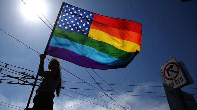 A same-sex-marriage supporter waves a pride flag while celebrating the U.S Supreme Court ruling regarding same-sex marriage on June 26, 2015, in San Francisco, California. 