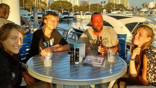 ​Ace Kimberly, center right, sits with sons Roger and Donny and daughter Rebecca in this photo posted to social media by the U.S. Coast Guard after the family went missing in a sailboat off Florida's southwest coast. 