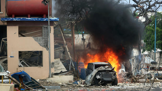 ​A vehicle burns at the scene of a suicide bomb attack outside the Nasa-Hablod hotel in Somalia's capital Mogadishu on June 25, 2016. 
