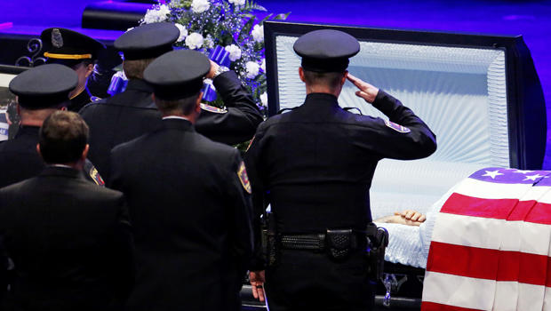 Police officers pay their respects ahead of the funeral for Officer Lorne Ahrens in Plano, Texas, on July 13, 2016. Five officers, including Ahrens, were killed in a shooting incident in Dallas on July 7, 2016. 