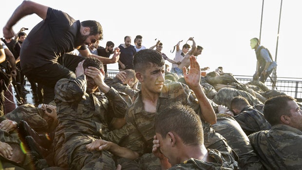 Soldiers involved in a coup attempt surrender on Bosphorus bridge on July 16, 2016, in Istanbul, Turkey. 