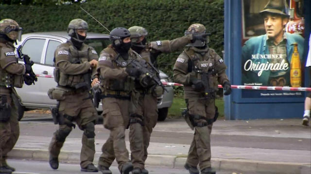 An image capture taken from video footage shows special forces police officers walking along a street outside the Olympia shopping mall following a shooting rampage in Munich, Germany, on July 22, 2016. 