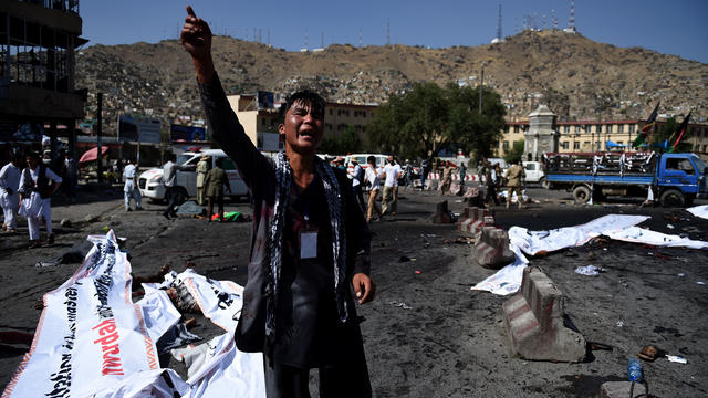 An Afghan protester screams near the scene of a suicide attack that targeted crowds of minority Shiite Hazaras during a demonstration at the Deh Mazang Circle in Kabul on July 23, 2016. 