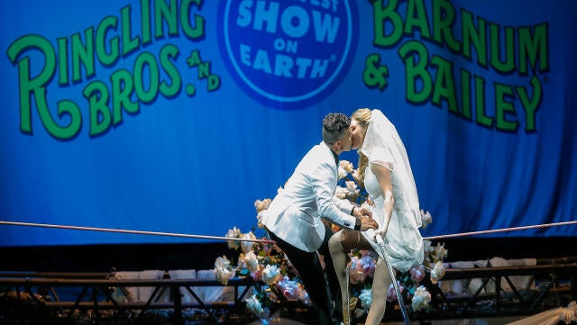 High wire walkers Mustafa Danguir and Anna Lebedeva of Ringling Bros. and Barnum & Bailey exchange wedding vows 30 feet above the NRG Stadium floor on a high wire that is no wider than a human thumb at NRG Park on July 26, 2016, in Houston, Texas. 