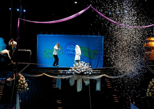 High wire walkers Mustafa Danguir and Anna Lebedeva of Ringling Bros. and Barnum & Bailey exchange wedding vows 30 feet above the NRG Stadium floor on a high wire that is no wider than a human thumb at NRG Park on July 26, 2016, in Houston, Texas. 