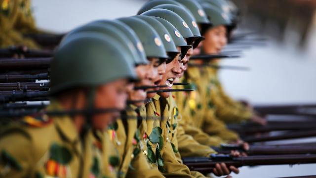 ​Soldiers shout slogans as they march past a stand with North Korean leader Kim Jong Un and other officials during the parade celebrating the 70th anniversary of the founding of the ruling Workers' Party of Korea, in Pyongyang Oct. 10, 2015. 