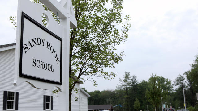 ​The sign for the new Sandy Hook Elementary School is pictured at the end of the drive leading to the school in Newtown, Connecticut, July 29, 2016. 