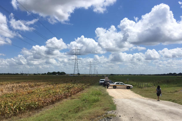 Police cars block access to the site where a hot air balloon crashed early July 30, 2016, near Lockhart, Texas. 