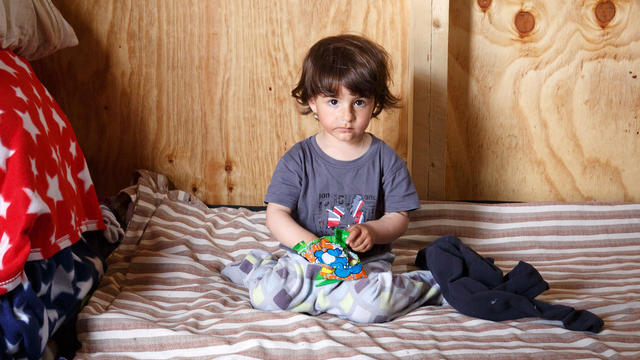 Madena Rashed, a two-year-old girl from Iraq, at the Grande-Synthe refugee camp in France. 