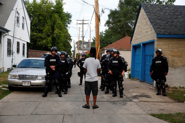 Police in riot gear assemble in an alley after disturbances following the police shooting of a man in Milwaukee, Wisconsin, Aug. 15, 2016.